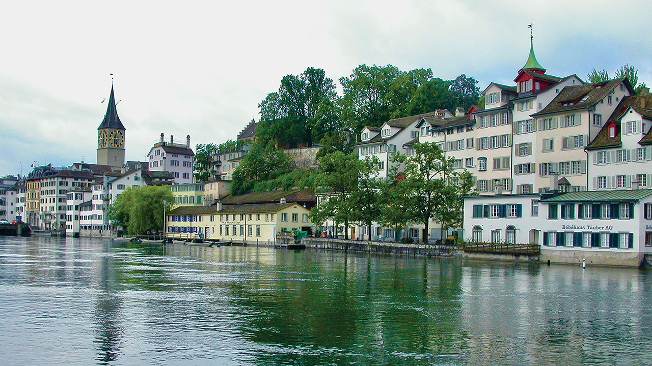 FAITHFUL UNTO DEATH — In Zurich, Switzerland, the birthplace of Anabaptism, Felix Manz became the city’s first Anabaptist martyr, drowned in the Limmat River on Jan. 5, 1527. Beyond the Manz martyrdom site on the opposite bank, a historical marker on a low stone wall lists Zurich’s Anabaptist martyrs. — John E. Sharp