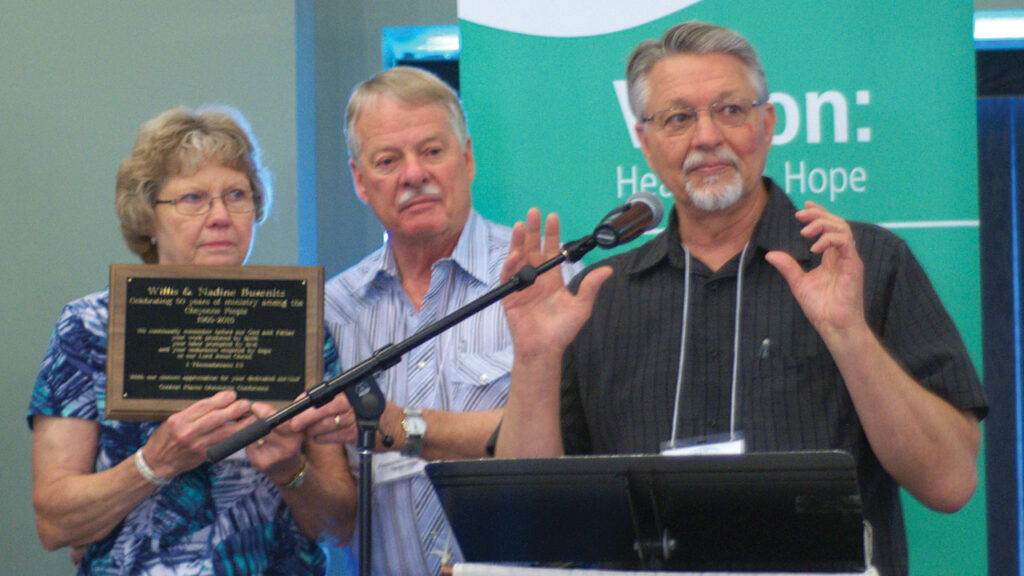 Nadine and Willis Busenitz, left, are honored for 50 years of ministry among the Cheyenne people in 2015 at a Central Plains Mennonite Conference event with conference minister Tim Detweiler. — Central Plains Mennonite Conference