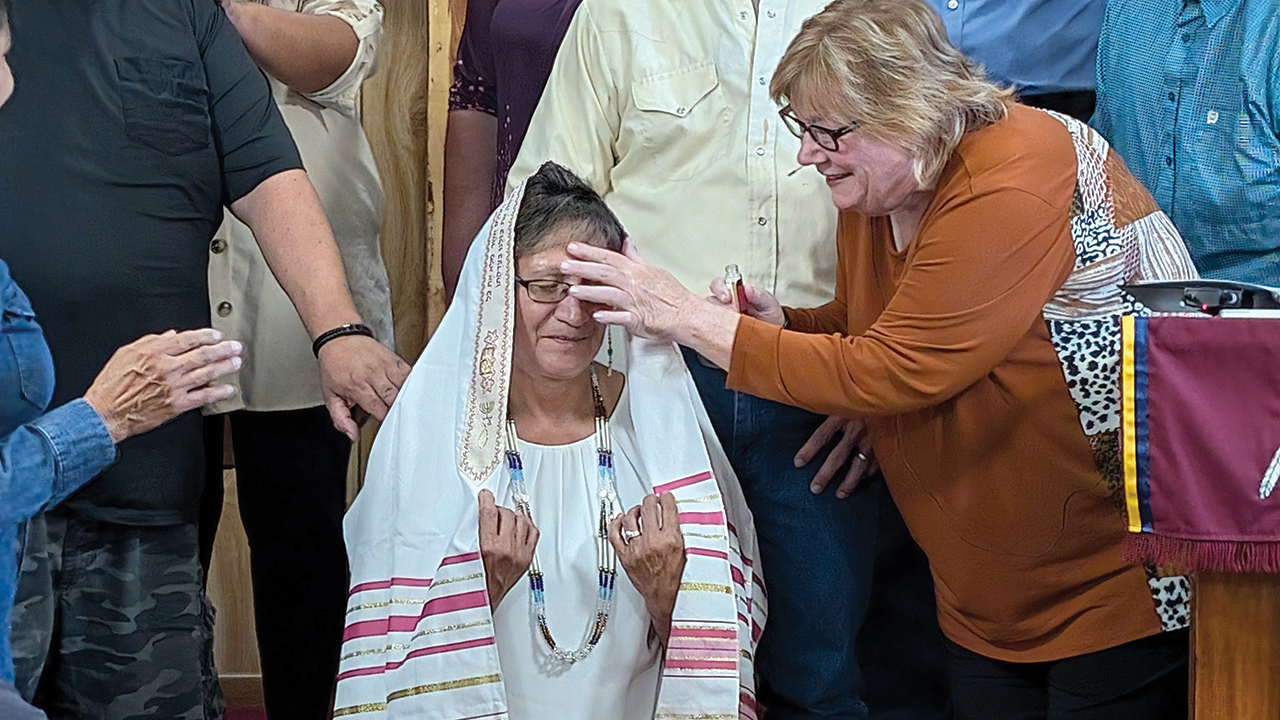 Suzette Shreffler is anointed by Central Plains conference minister Susan Janzen on Sept. 22 at White River Cheyenne Mennonite Church in Busby, Mont. — Nathan Luitjens/CPMC