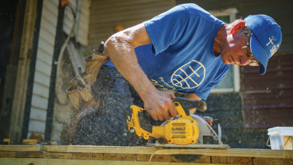 Lee Martin cuts wood to fit a doorway in Kimball, W.Va., on June 4, 2024. — Christy Kauffman/MCC