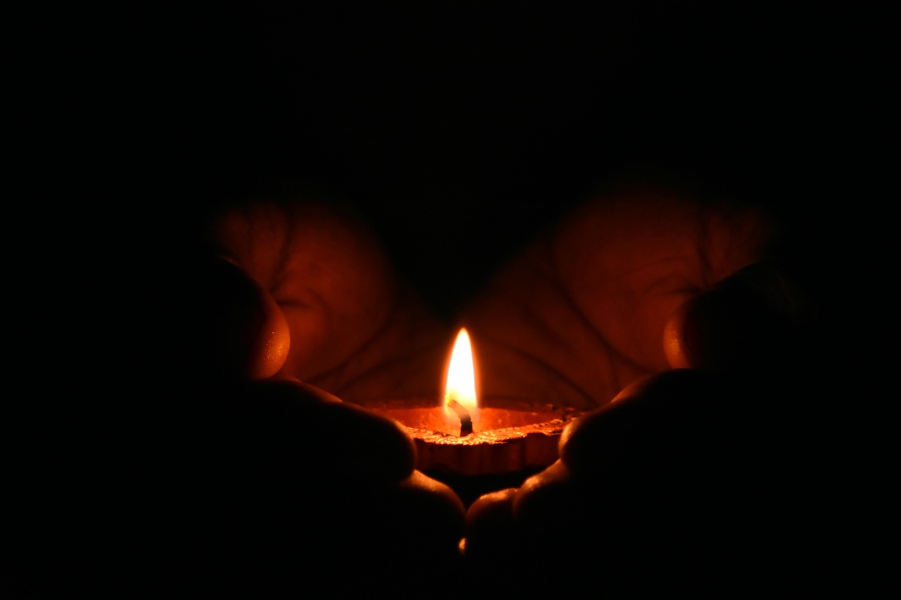 candle in cupped hands