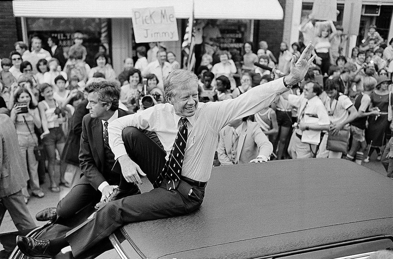 President Jimmy Carter waves from the roof of his car along the parade route through Bardstown, Ky.
