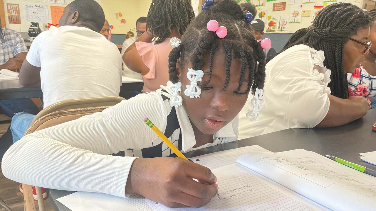 Saurine Saradjie, whose family came from Haiti, works on a lesson in an English class that meets during the Sunday school hour at Lima Mennonite Church in Ohio. — Jeff Boehr