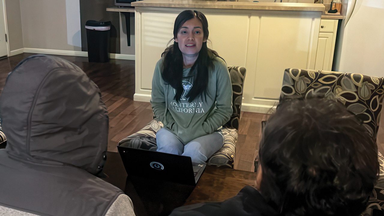Crystal Fernandez-Benites, West Coast MCC immigration caseworker, interviews two community church members affected by the changes in immigration policy. — Dina Gonzalez Pina/MCC