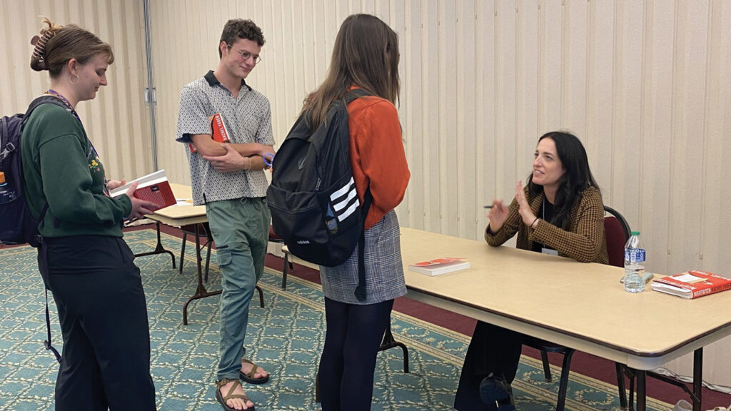 Rachel Yoder signs copies of Nightbitch in 2022 at the Mennonite/s Writing Conference at Goshen College. — Goshen College