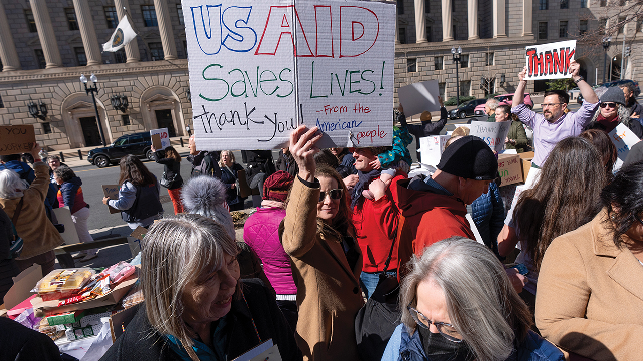 On Feb. 28 in Washington, Barbara Singer of Bethesda, Md., holds a sign in support of USAID workers who were fired. — Jacquelyn Martin/AP