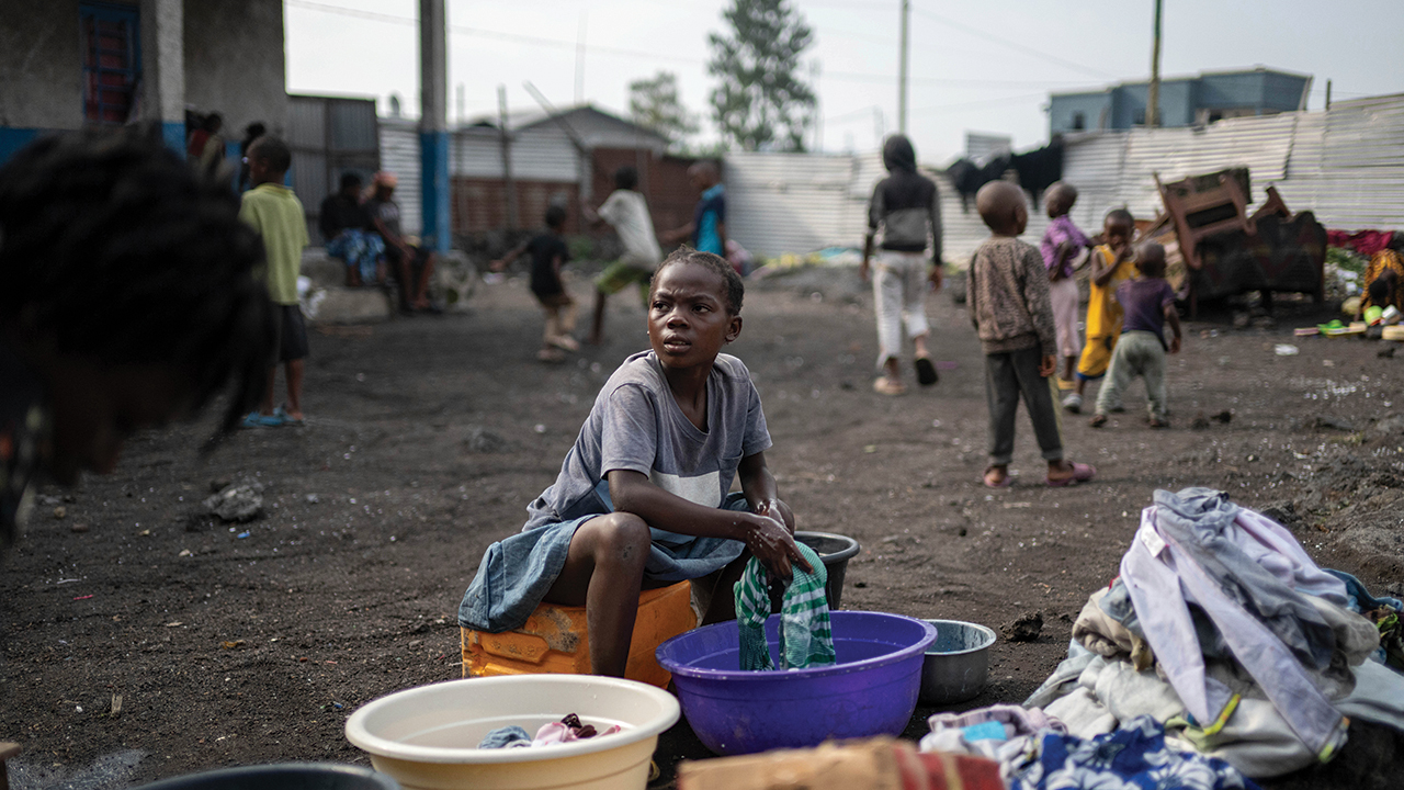 Laini, 11, washes clothes on Feb. 18 at a school in a Goma, eastern Democratic Republic of Congo, where she found shelter after her soldier father was sent to Rumangabo, a military base, for integration into the M23 rebel forces. — Moses Sawasawa/AP