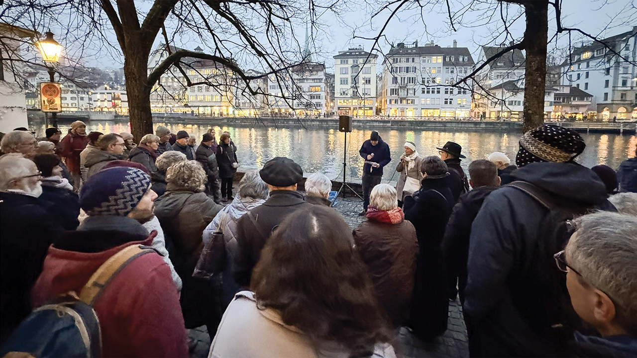 A crowd gathers at an Anabaptist memorial on the Limmat River in Zurich, Switzerland, as part of the Swiss Mennonite Conference’s celebration of 500 years of Anabaptism. — Swiss Mennonite Conference
