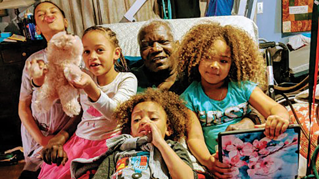 “Enjoying my grandchildren when I became bedridden in Fresno.” — Courtesy of Pakisa K. Tshimika