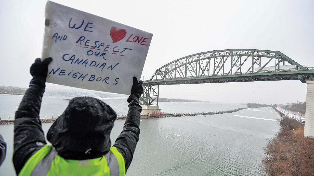 An “Elbows Up for Canada” protester holds a sign near The Peace Bridge border crossing in Buffalo, N.Y., April 2. — Adrian Kraus/AP