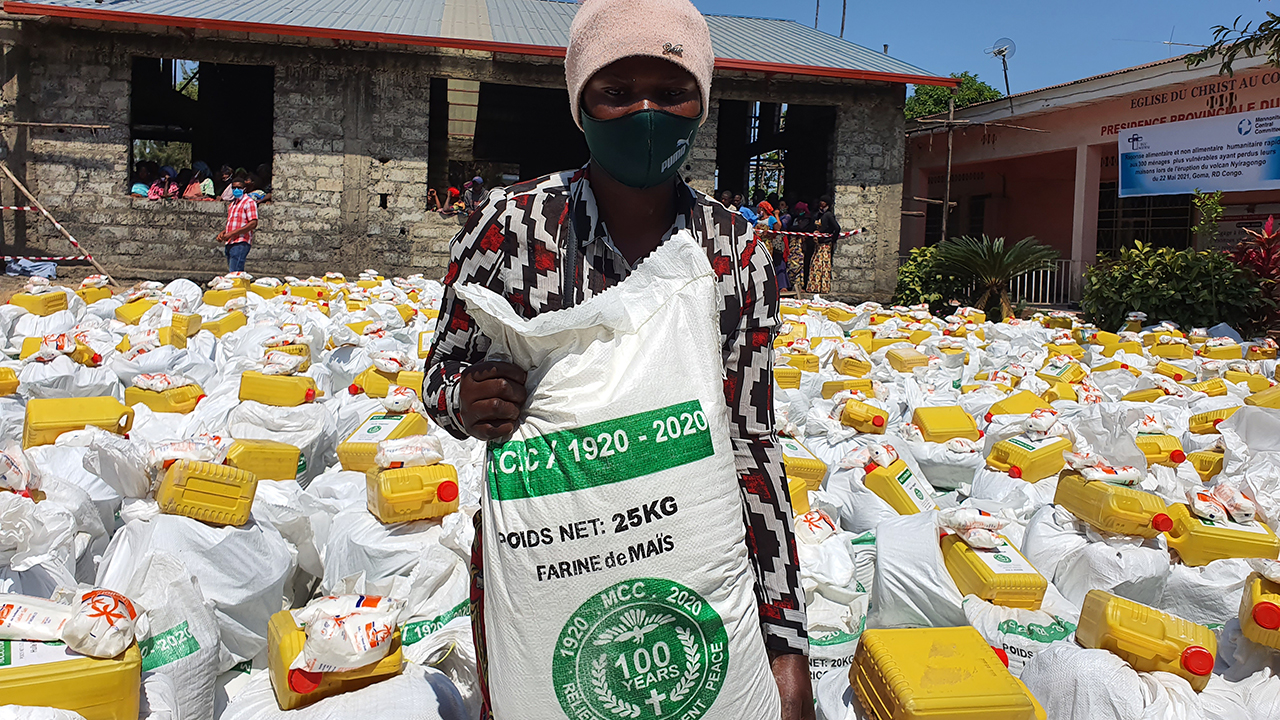 Rebecca Kasemengo, from the Buhene area, at the June 2021 distribution of emergency relief items, including maize flour, beans, vegetable oil, salt, blankets, pots, plates and cups, to families in the Buhene and Bugeregere communities in Goma, Democratic Republic of the Congo, whose homes were destroyed by volcanic lava. — Mulanda Jimmy Juma/MCC