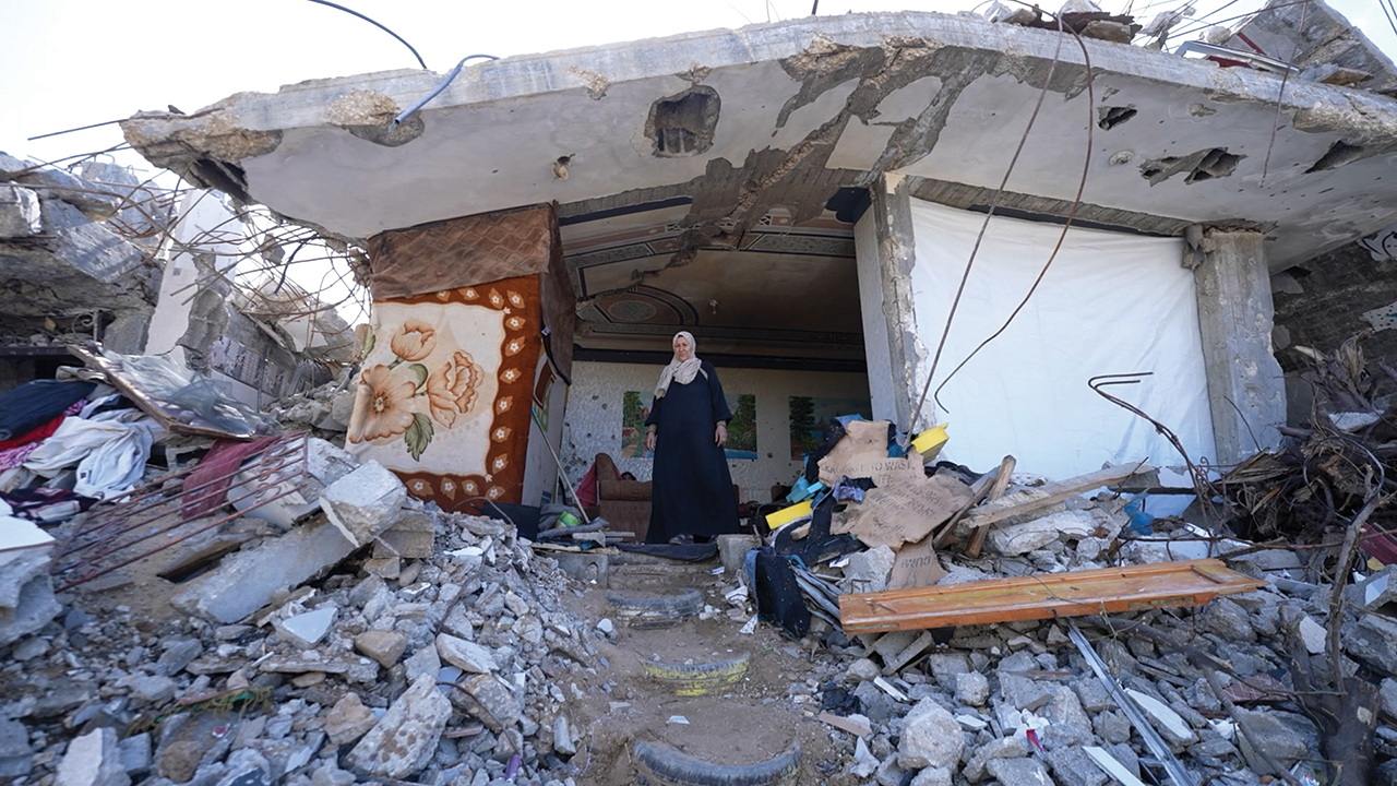 Khayria stands at the opening of the one room of her house in northern Gaza that survived the Israeli military’s bombing. —Mahmoud Meqdad/MCC