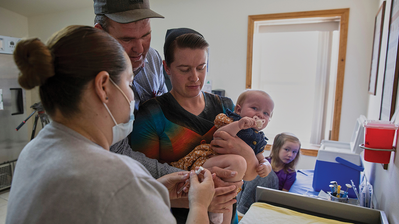 Mennonites Abraham Fehr and Katarina Wall hold their baby as he gets vaccinated weeks after the family fell sick with measles in Cuauhtemoc, Mexico, May 1. — Megan Janetsky/AP