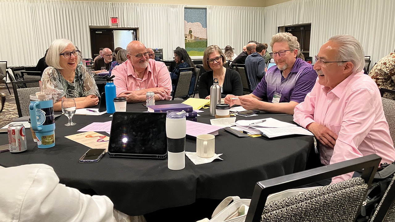 Sharon Witmer Yoder, left, conference minister of Indiana-Michigan Mennonite Conference; Mick Sommers, associate conference minister of Atlantic Coast Conference; Amy Yoder McGloughlin, conference minister of Allegheny Mennonite Conference; Eric Buller, moderator of Western District Conference; and Richard Aguirre, Mennonite Church USA Executive Board member; talk during the Constituency Leaders Council meeting. — Paul Schrag/AW