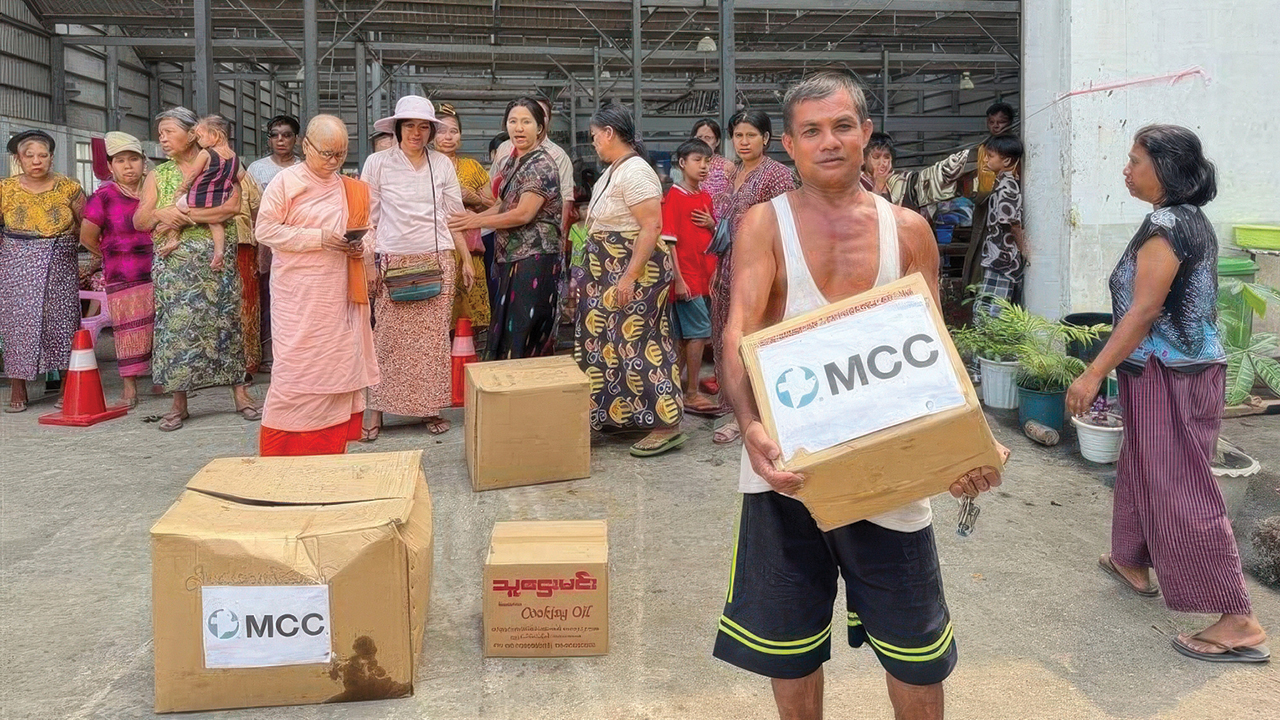 A man from an MCC partner organization in Myanmar distributes food and relief supplies to people affected by the March 28 earthquake. — MCC Partner