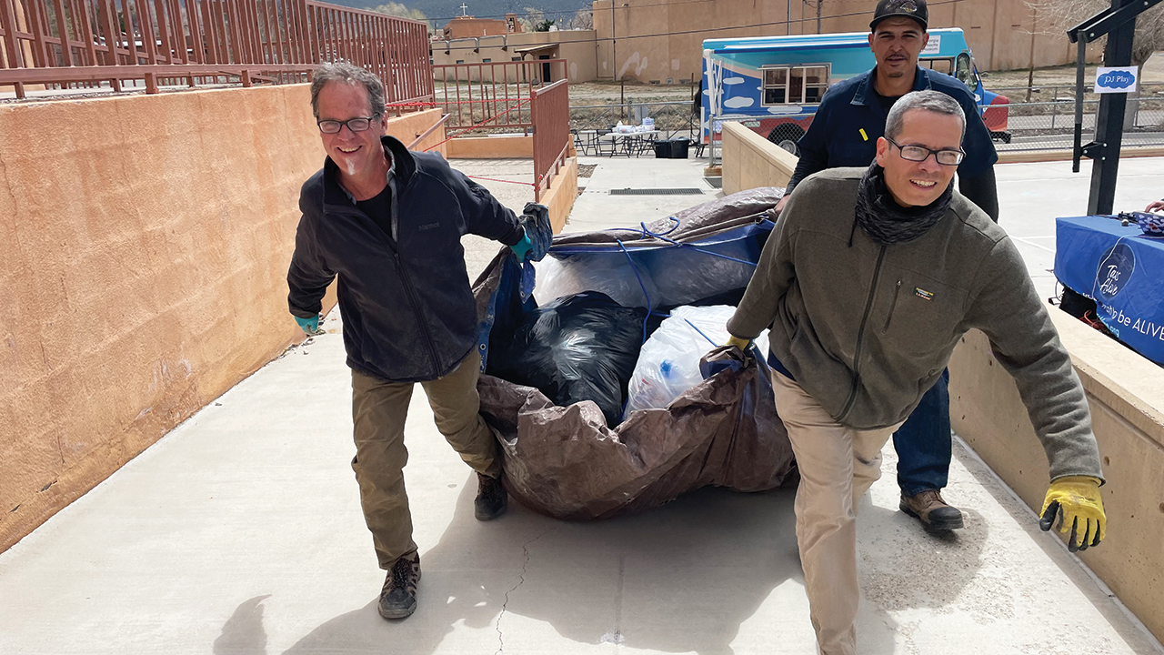 Todd Wynward, John Espinosa and Randy Martinez bring a load of plastic to a community “Invent Event,” where they taught students to construct Redi-Walls. — Courtesy of Todd Wynward