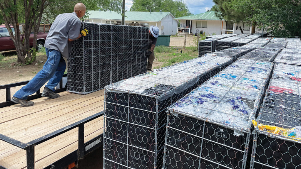 Randy Martinez and Daniel “Ryno” Herrera of TiLT’s Repurposing Plastic Project deliver a batch of Redi-Walls to a construction site. — Todd Wynward