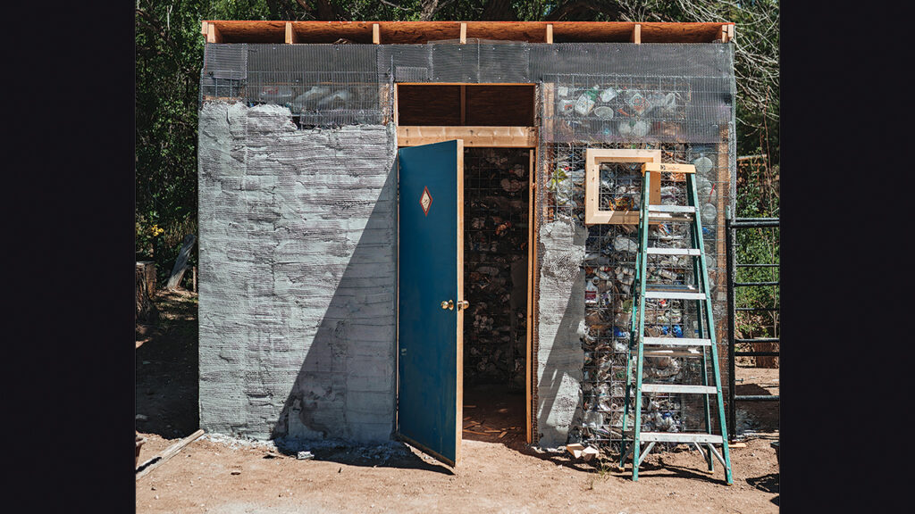 This shed in Questa, N.M., was the Repurposing Plastic Project’s pioneer project. The trash visible in the walls was later hidden behind a layer of stucco. — Juan Perez