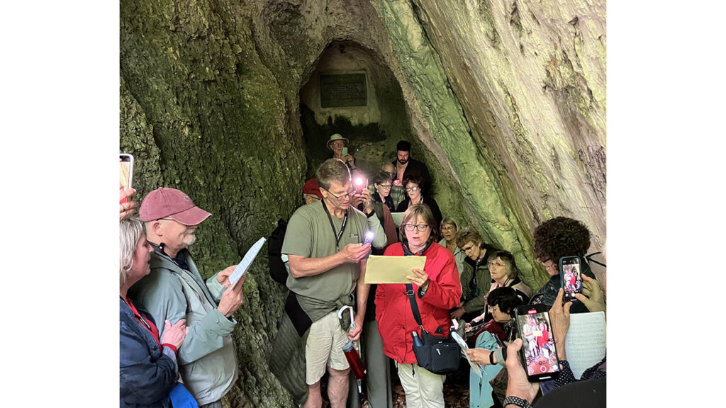 The tour group sings in the Jura Täuferhöhle, a secret cave where fugitive Anabaptists worshiped. — Paul Schrag/AW