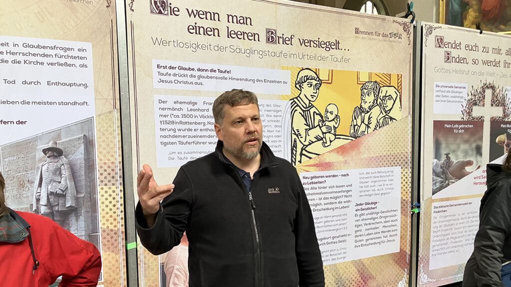 Peter Brandes, a Baptist pastor in Salzburg, Austria, talks about the Anabaptist history exhibit he helped organize, displayed at the Kirche St. Andrä in Salzburg. — Paul Schrag/AW