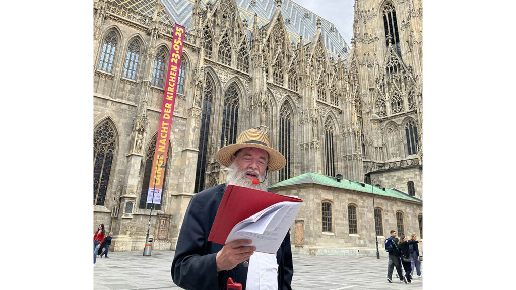 Alexander Basnar of Krumau am Kamp, Austria, talks about Anabaptist history in the courtyard by St. Stephen’s Cathedral in Vienna. — Paul Schrag/AW