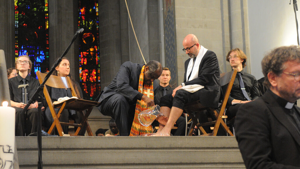 Setri Nyomi, interim general secretary of the World Communion of Reformed Churches, washes the feet of César García, general secretary of Mennonite World Conference, during the worship service celebrating the 500th anniversary of Anabaptism in Zurich, Switzerland, on May 29. — Dale D. Gehman for AW