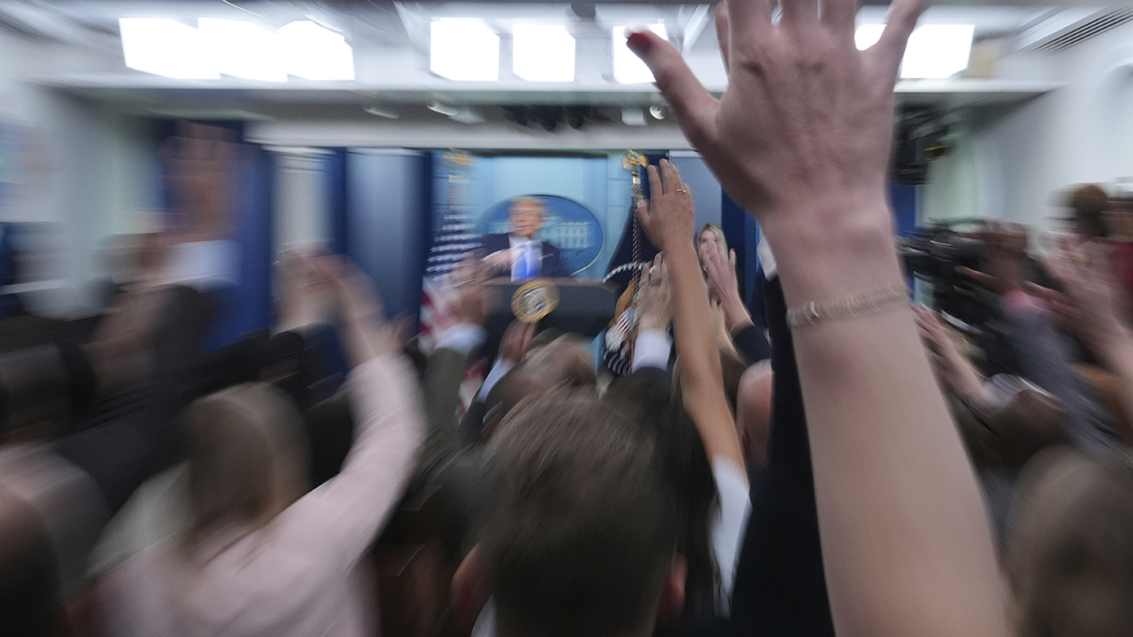 Reporters raise their hands to ask a question as President Donald Trump speaks to the media on June 27 in the briefing room of the White House. — Jacquelyn Martin/AP