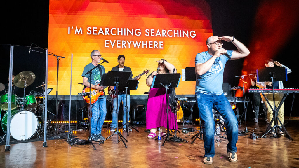 Band leader Randall Koehler leads the crowd in singing “Akekho Ofana No Jesu,” a song about searching everywhere but finding no one like Jesus. Other band members are Hector Martinez on drums and, from left, Lee Ebersole, Samuel Vazquez, Morgan Koehler and Amy Hofer Vetch. Not visible is Chelsea Vaught. — MiccicheCorporate.com for MC USA