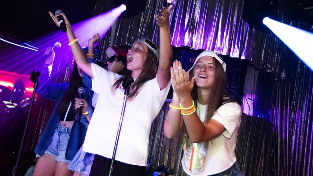 Youth engage the audience during karaoke at THE BOP youth party. — Juan Moya/AW