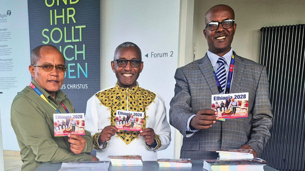 Ethiopian delegates to the Mennonite World Conference General Council meetings in Germany in May — from left, Gishu Ebissa, Kelbessa Demena and Desalegn Abebe — invited Anabaptists around the world to the 2028 assembly in Ethiopia, an invitation now canceled. — MWC
