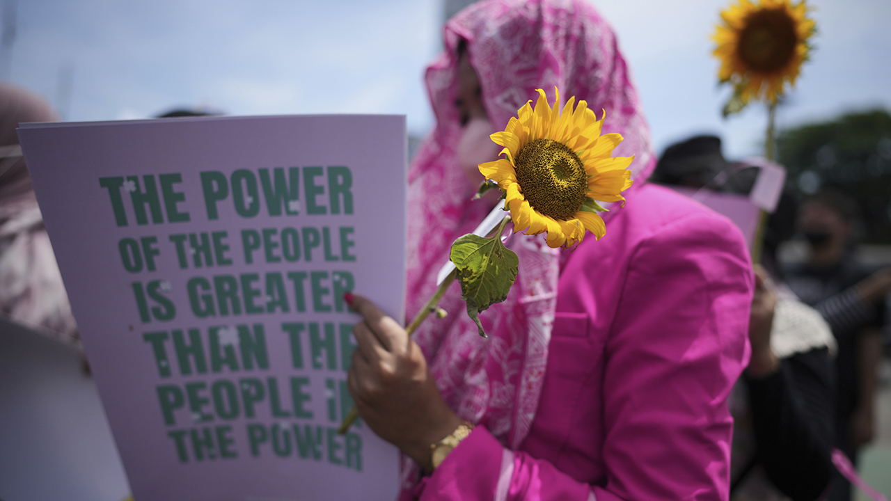 In Jakarta, Indonesia, on Sept. 3, an activist holds a sunflower during a rally denouncing violence allegedly committed by police during protests against lavish allowances given to members of parliament. — Dita Alangkara/AP