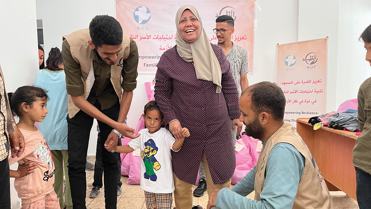 Distributing new clothing to children brings joy to Rifqa Al-Hamalawi, leader and founder of Al-Najd Developmental Forum, seen here in May. — Al-Najd Developmental Forum