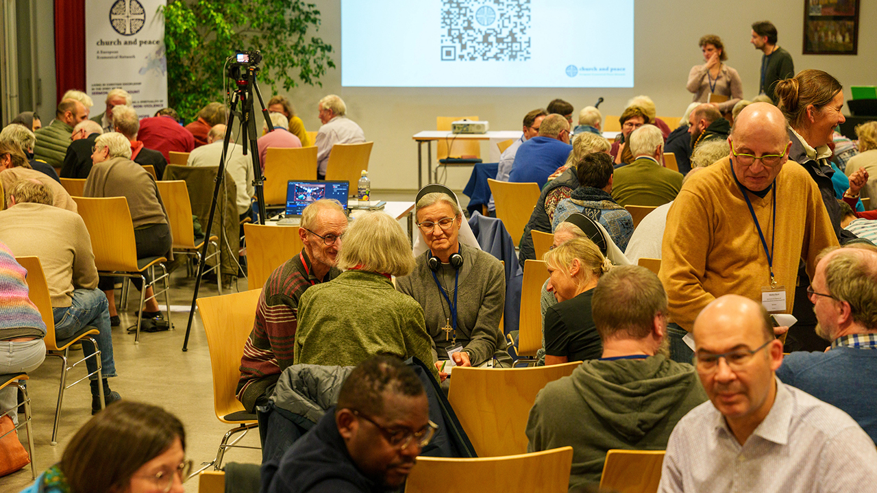 Attendees at the 2025 Church & Peace European Conference speak in small groups in October at Herrnhut Moravian Church in Germany. — Church & Peace
