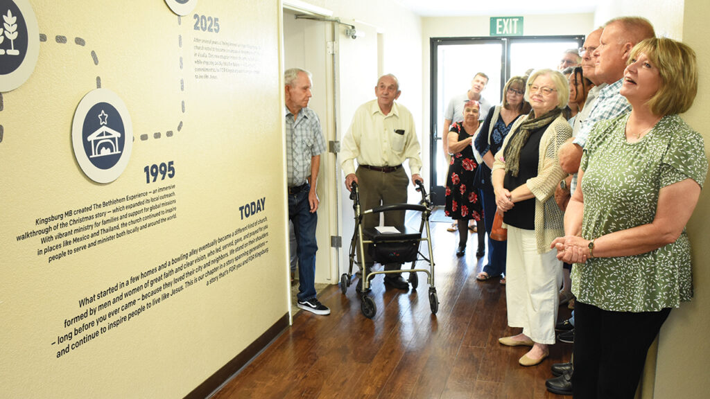Members of Hope Kingsburg look at the new legacy wall highlighting milestone moments in the church’s history. — Steve Wiest