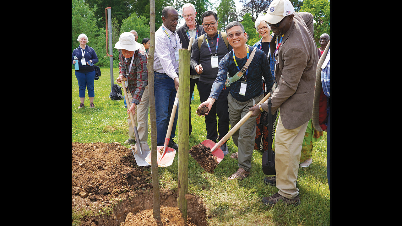 Mennonite World Conference regional representatives Pablo Stucky (Andean region), George Broughton (Caribbean), Gerald Hildebrand (North American), Agus Mayanto (Southeast Asian), Jeremiah Choi (Northeast Asian) and Siaka Traoré (West/Central African) plant a tree during MWC General Council meetings May 23 in Schwäbisch Gmünd, Germany. — Irma Sulistyorini/MWC
