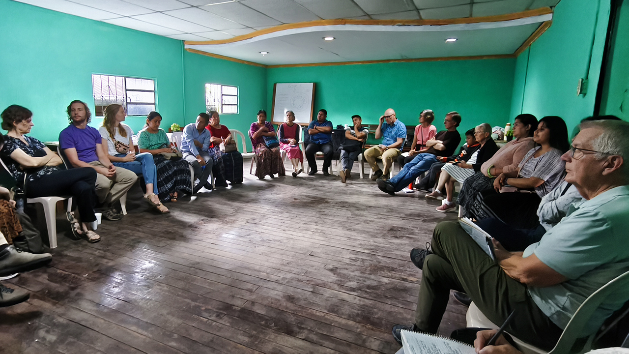 SEMILLA CASAS learning tour participants meet with K’ekchi’ Mennonite Conference leaders in Alta Verapas, Guatemala. — Karla María Cuca Vásquez/SEMILLA
