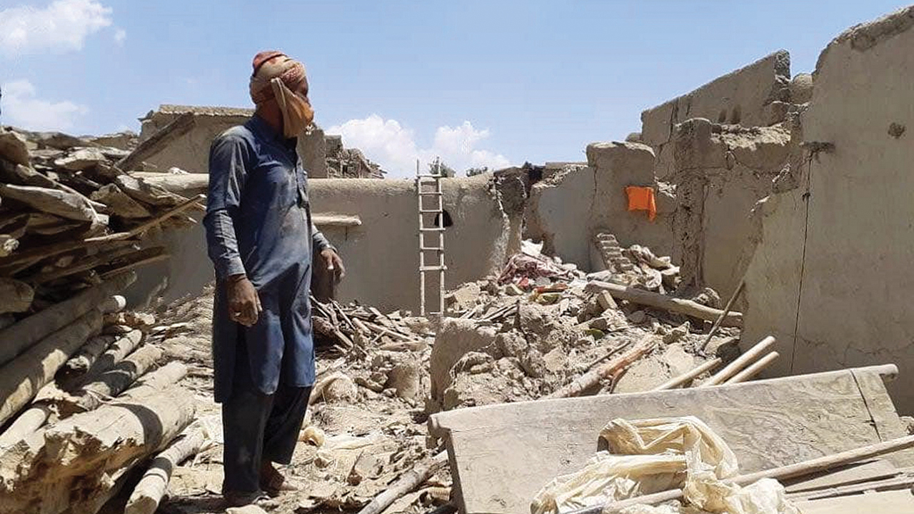 A man stands next to his destroyed house after a 6.0 magnitude earthquake struck eastern Afghanistan on Aug. 31. Over 2,200 people were killed, 3,600 injured and more than 6,700 homes destroyed. — Courtesy of an MCC partner
