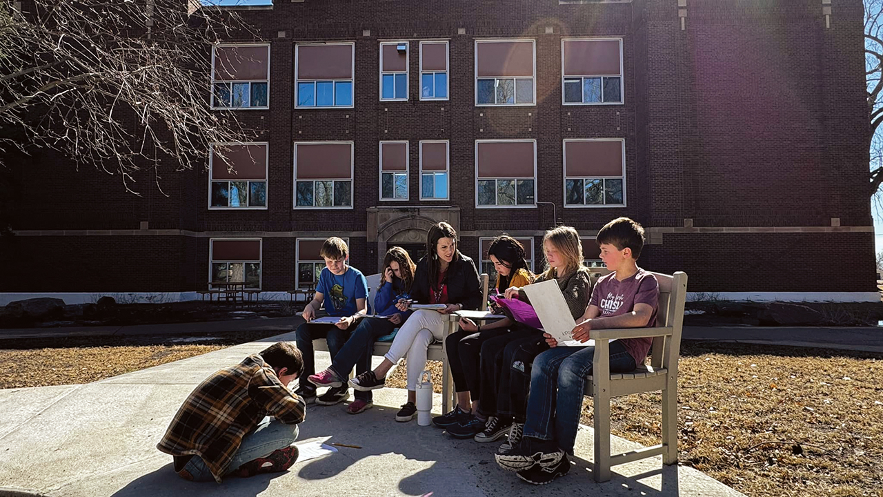 Freeman Academy 5th and 6th graders study in 2025 with teacher Amber Bradley in front of Memorial Hall, built in 1926. — Freeman Academy