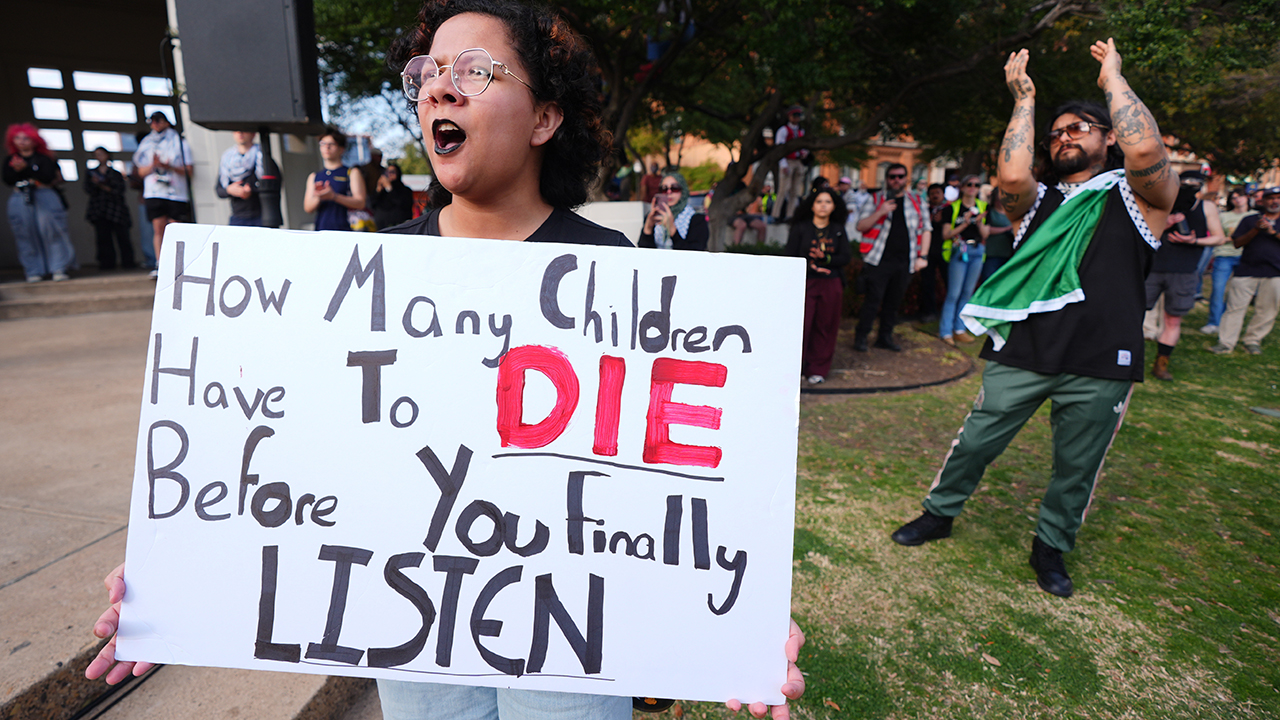 A woman holds a sign during an antiwar demonstration in Dallas on March 1. — LM Otero/AP
