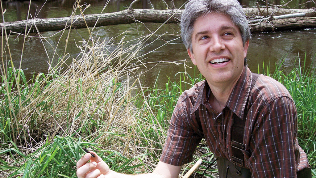 In 2009, Douglas Day Kaufman holds a caddisfly larva found in the Elkhart River. — Ron Kennel