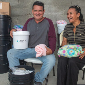 Yoel Barbusano Pérez and Deyli Miliam Pérez, co-pastors of Jesús Te Llama Hoy (Jesus Calls You Today) in Caibarién, Cuba, received MCC relief items in July that they took back to their church for distribution, including infant care kits, relief kits, school kits and canned meat. — Alfredo Sarabia/MCC/Fairpicture