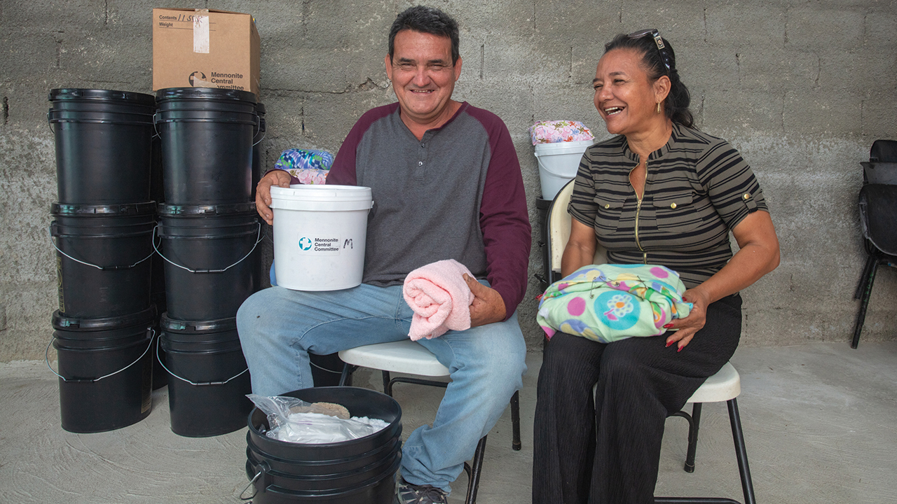 Yoel Barbusano Pérez and Deyli Miliam Pérez, co-pastors of Jesús Te Llama Hoy (Jesus Calls You Today) in Caibarién, Cuba, received MCC relief items in July that they took back to their church for distribution, including infant care kits, relief kits, school kits and canned meat. — Alfredo Sarabia/MCC/Fairpicture