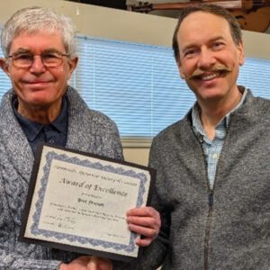 Bert Friesen, left, receives the Mennonite Historical Society of Canada’s Award of Excellence in January from MHSC President Conrad Stoesz. — MHSC