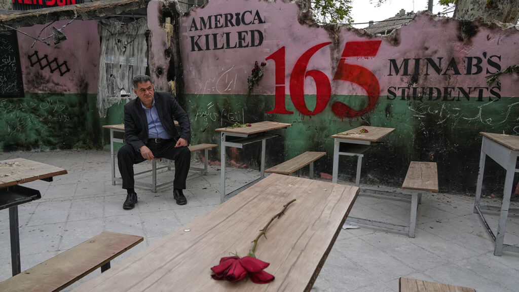 A man sits April 12 on a bench in a memorial, set for the school children who were killed during a strike on a school in southern town of Minab on Feb. 28, in northern Tehran, Iran. — Vahid Salemi/AP