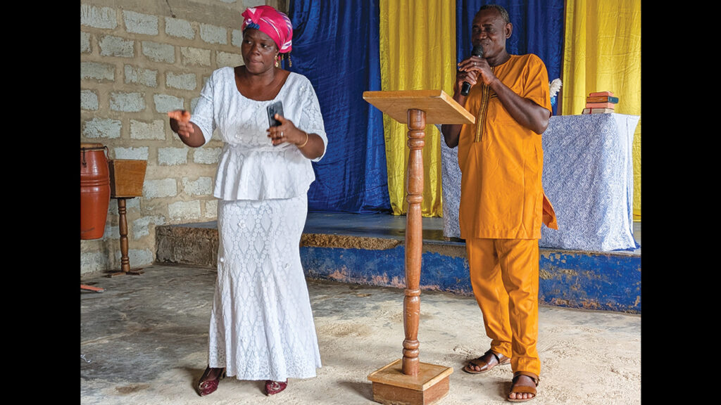 Pastor Emelia Amexo, left, interprets for Francis Dzivor, moderator of Ghana Mennonite Church, as he delivers a sermon in English at Trinity Chapel. — Wil LaVeist/MMN