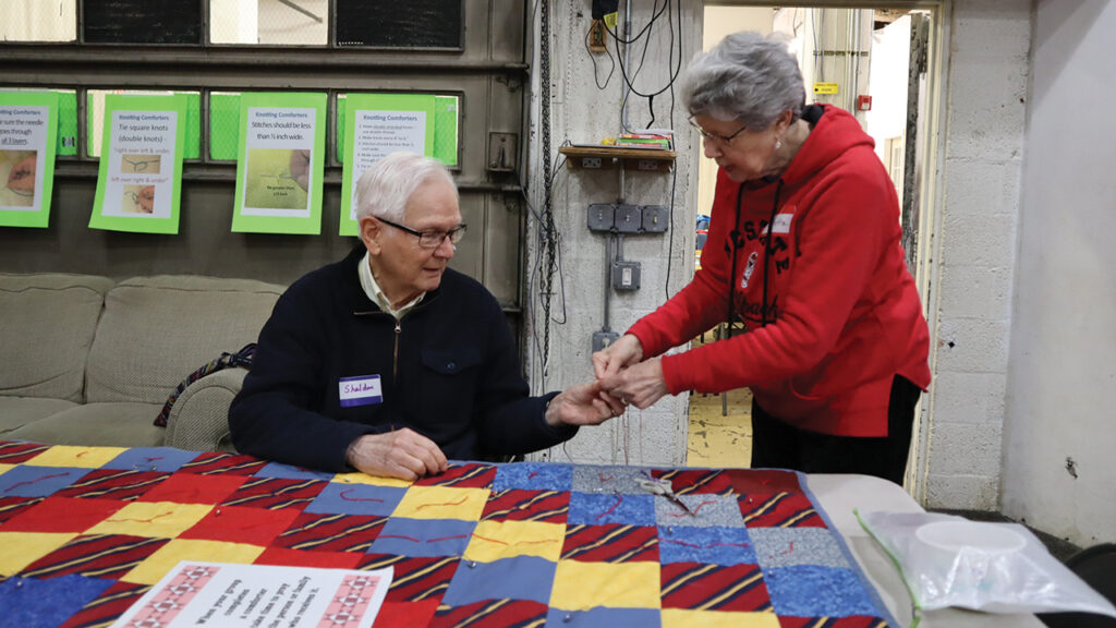 Sheldon and Marietta Sawatzky work together to finish a comforter. — Laura Pauls Thomas/MCC