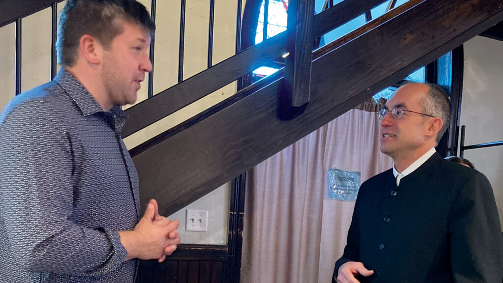 Urban Mennonite Missions executive director Laverne Eberly, left, speaks May 3 with Hampden Mennonite Church Pastor Nathan Zook. — Havilah Zook