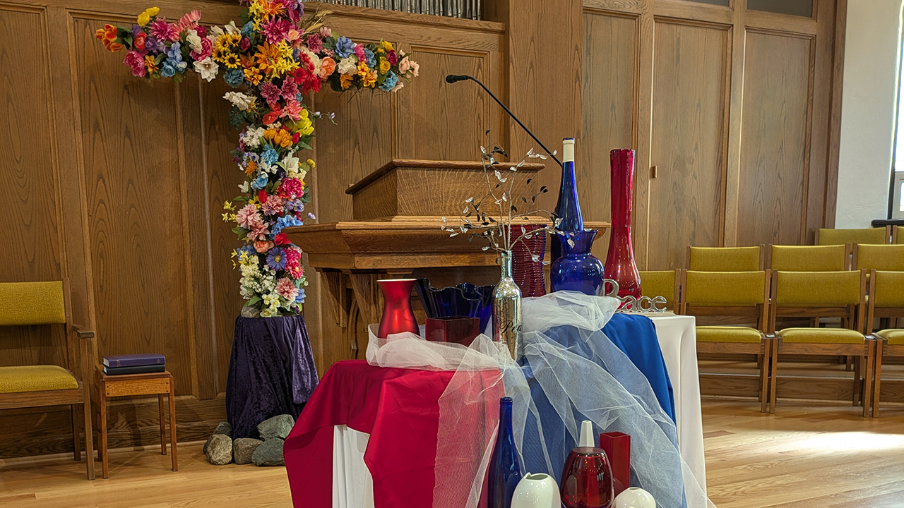 On the first Sunday of the “U.S.A. at 250” worship series, the chancel of First Mennonite Church of Bluffton, Ohio, was decorated in red, white and blue. — Courtesy of Phil Yoder