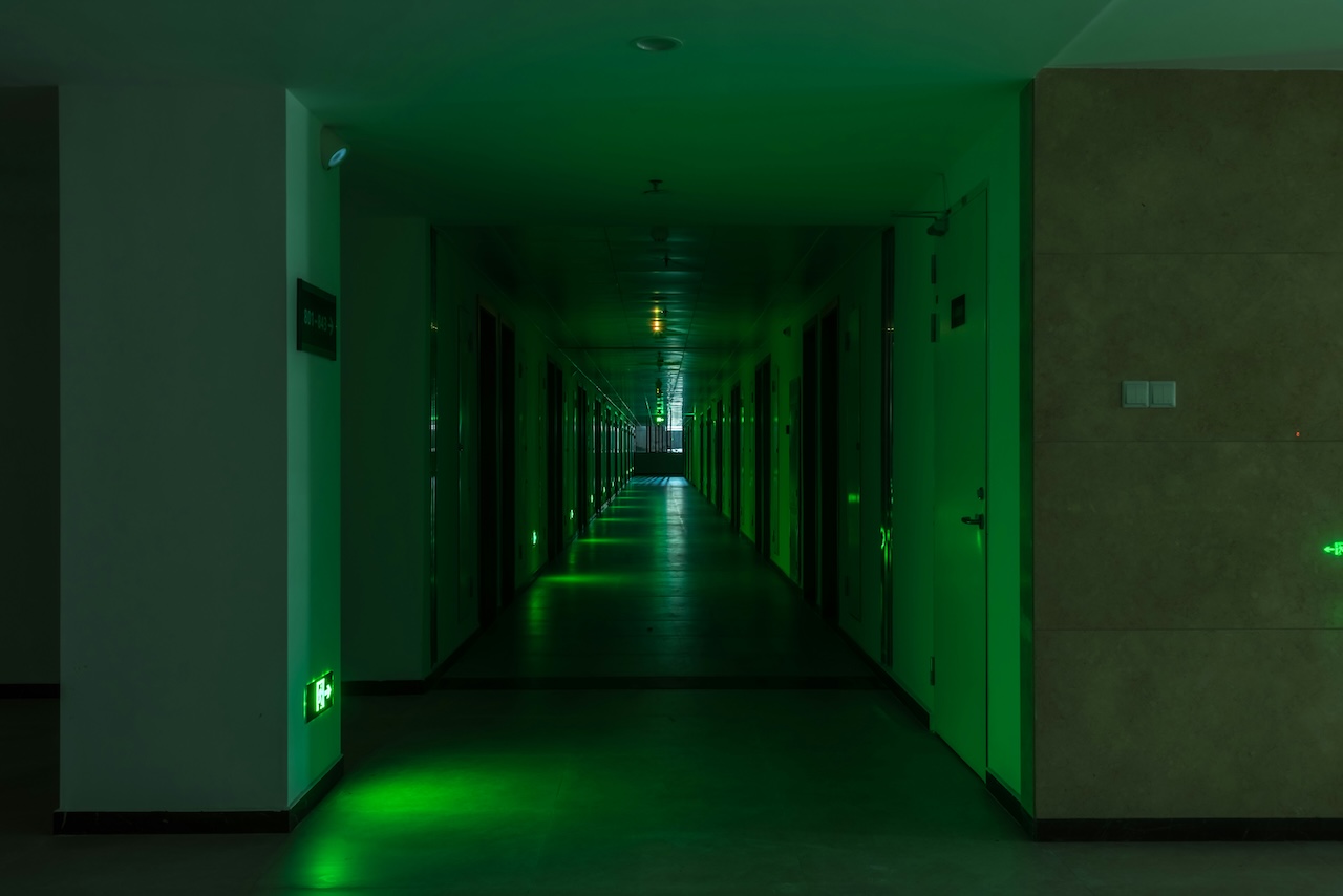 green, dimly-lit hallway