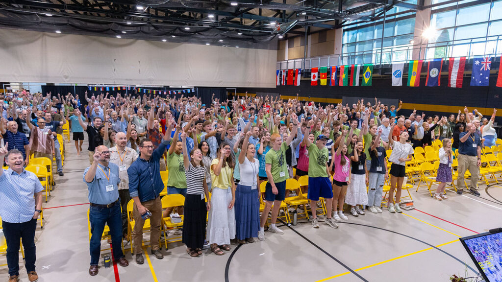 Worshipers take a group selfie, pointing upward and yelling “Jesus,” on Sunday morning. — Jonathan Charles for AW
